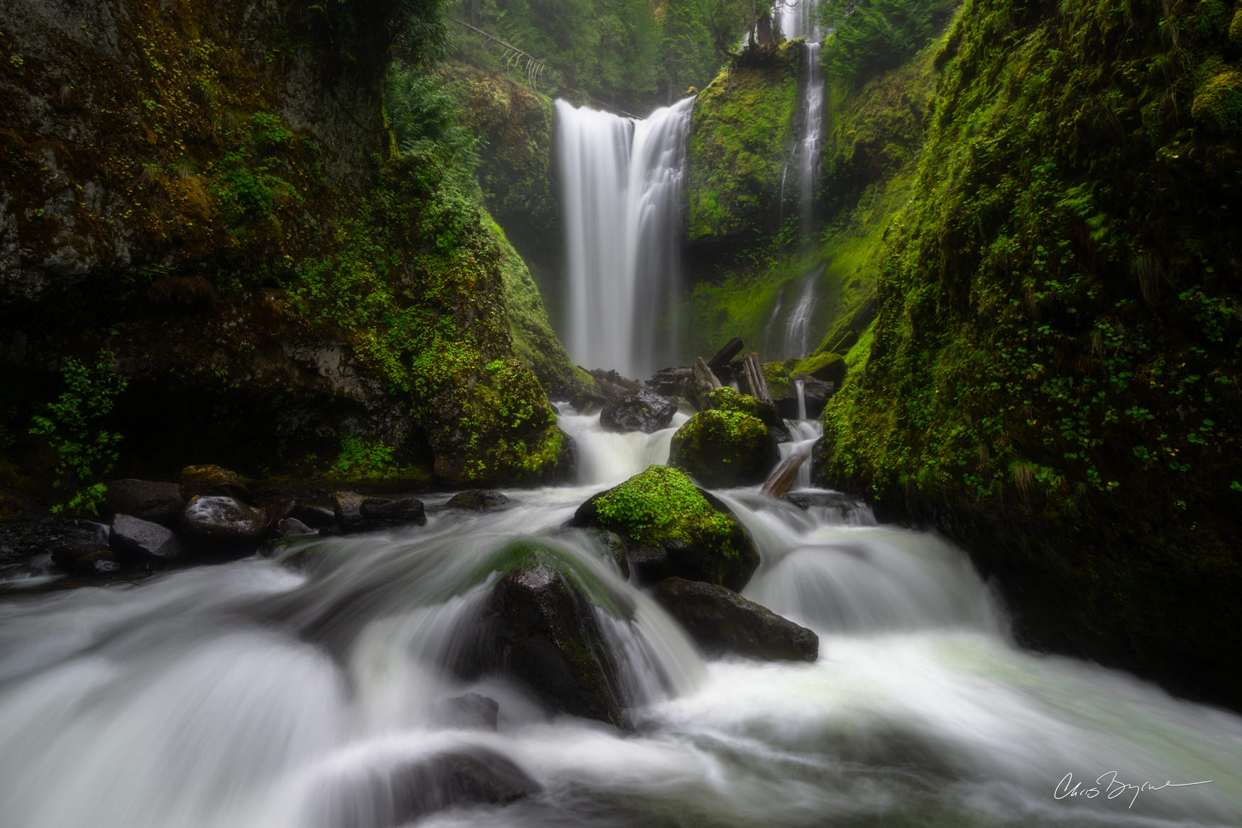 WATERFALL WINDOW Falls Creek Falls in Washington is an iconic location, often photographed from an upper tier where people stand to capture a...
